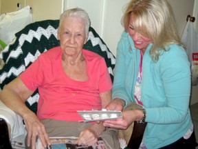 Tracey Stevens, a personal support worker with the Assisted Living Care program of the Canadian Red Cross in Timmins, assists her client Rita Bozicovich for managing her medications. Medication administration is a common task for personal support workers assisting seniors.