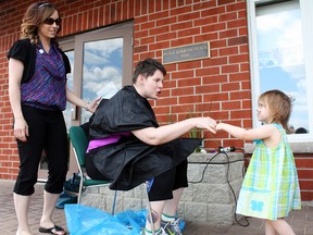 Prior to getting her head shaved to raise awareness for epilepsy, Kerry Gorman gets some last-minute encouragement from young fan Kaitlyn Clements, right. The Walk or Run for Fun for Epilepsy began at the Seizure and Brain Injury Centre on Ross Ave. and continued around Gillies Lake on Saturday. Gorman was able to raise more than $3,000 through her efforts for the centre. Laurie-Anne Tremblay, left, from Sears Hair Salon was on hand to help out with the trim.