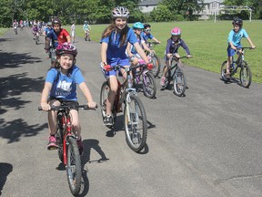 Sisters Leah, top, and Megan Cross, front, participated in a bike rodeo at Mother Teresa Catholic School Friday to raise funds for cancer research. Megan has twice been diagnosed with cancer.
Michael Lea The Whig-Standard