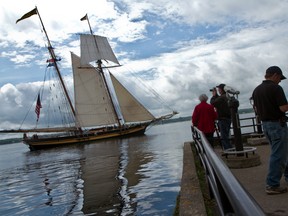 A small crowd gathers to watch ‘The Pride of Baltimore II’ sail off into the St. Lawrence River on Monday morning. The tall ship was one of 10 that drew thousands of visitors to Brockville's waterfront for the city's inaugural Tall Ships Festival over the weekend. (THOMAS LEE/The Recorder and Times)