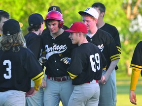 Chaz Brown of the Portage midget team is congratulated by the rest of his teammates after hitting a walkoff single during a game against Carman June 17. (Kevin Hirschfield/THE GRAPHIC/QMI AGENCY)