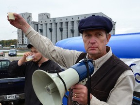 Michael Schmidt raises a glass of raw milk in a toast to his supporters at a raw milk rally outside the Grey Bruce Health Unit in Owen Sound in October 2011.