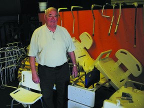 Ken Stewart stands amid the clutter of medical equipment that he collects, fixes and distributes to the needy. Stewart has been awarded the Governor General's Caring Canadian award for his volunteer activities.          Wayne Lowrie - Gananoque Reporter