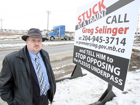 City councillor Russ Wyatt displays a sign that he erected on Plessis Road in March 2011.  (Winnipeg Sun files)