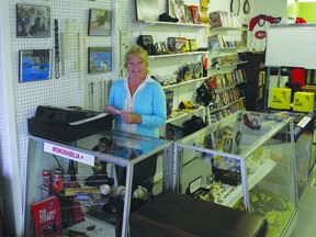 Katheryn White shows off some of the wares at her new store, Storage War Discoveries, located on the main street of Lansdowne. The store will open at 9 a.m. on Saturday, June 22.           Wayne Lowrie - Gananoque Reporter
