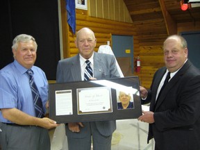 President of the Board of Directors, Al Mochoruck (left) and Arborfield Board Member, Rick Lindsay (right) present the Order of Merit Award to W Bruce Smith during the Diamond North Credit Union Member Appreciation Supper on June 7.