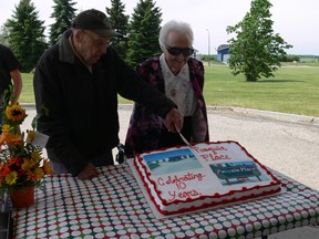 Original residents Don Gray (left) and Naomi Cowherd (right) cut the birthday cake at Pasquia Place’s tenth birthday and community thank you celebration on June 13 in Carrot River.