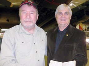 Kenora resident Bill Friday presents his father’s RCAF log book from the original Mynarski Lancaster VRA to Canadian Warplane Heritage Museum CEO Dave Rohnen  on June 7, 2013.