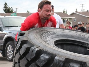 Melfort product Quinton Falk uses all his strength to flip a tractor tireduring the competition on Friday, June 14.