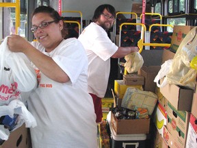Volunteers help sort donated groceries during the Stuff-the-Bus food drive in 2011. (Observer file photo)