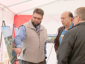 Deon Wilner, manager, environmental infrastructure with ISL Engineering and Land Services, points out some of the features of the new water treatment plant to Town of Drayton Valley Manager Manny Deol and former town councillor Gary Carter on June 14.