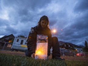 Firefighter Mary Kapitza does her part to light luminaries in honour of those fighting cancer as well as those who lost their lives to the disease during the 2013 Canmore/Banff Relay for Life. Justin Parsons/ Canmore Leader/ QMI Agency