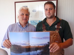 Carlo Corsini and his son Adriano display the new coffee table book about Mud Creek Club, one of Canada's oldest waterfowl hunting clubs, located near Mitchell's Bay, which has been owned by the Corsini family since 1977. Photo taken Friday, June 14, 2013 in Mitchell's Bay, ON.
BOB BOUGHNER/ THE CHATHAM DAILY NEWS/ QMI AGENCY