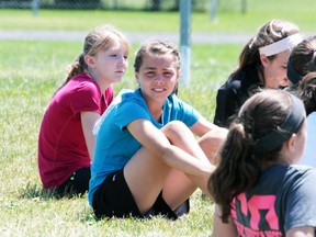 Jadyn Pettenuzzo (blue shirt) looks on prior to the pee wee girls 4x100-metre relay race on Tuesday. Pettenuzzo was sensation at the H-SCDSB’s track and field championships, setting two new city records.