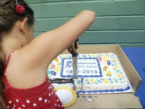 Cutting the cake at Lakewood Public Schools farewell party on Tuesday evening, June 18. 
ALAN S. HALE/Daily Miner and News