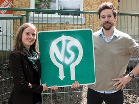 Daniel Laforest and Erika Luckert display the Vertical Suburbia logo in the Old Strathcona area. KEVIN MAIMANN Edmonton Examiner