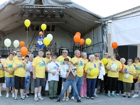 Espanola’s fifth annual Relay for Life raised more than $30,000 this year bringing a five-year total to over $250,000. Survivors wearing bright yellow shirts were about to release balloons symbolizing their years free of cancer. Photo by Dawn Lalonde/Mid-North Monitor/QMI Agency