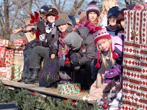 Recent students from Timothy Christian School peer around the side of their float during a parade in Morrisburg. The school is marking 50 years of education this year will be holding a reunion at the end of June.  
Staff file photo