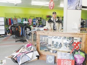 Father-in-law Stan Kroening stands at the massive counter he built for the new store. There’s still plenty of organizing and decorating to do, but Thrash’n Threads is open for business.