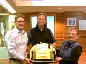 Brent Clair accepts the gift of some Skills Competition bags from GPRC Fairview College Dean of Trades and principal Chris Laue and NW Regional Skills Competiton Coordinator Shirley Lyman after he presented them with a cheque for $3.000.