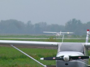 A Cessna 150 lands at Fairview Airport for the COPA Fly-in pancake breakfast.