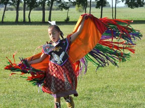 Gloria Pelletier, 8, performs a fancy shawl dance at the Pow aboriginal dancing program windup Tuesday night behind La Verendrye School. Pelletier's mom says the girl has been dancing since she was 1 year old. (CLARISE KLASSEN/PORTAGE DAILY GRAPHIC/QMI AGENCY)