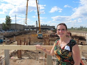 Mayor Melissa Blake poses near the future site of the Waters Edge condominium complex on Wednesday. LiAM Construction held a launch party, celebrating construction of the building, which will also host retail space.