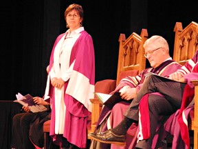 Kim Pate, a lawyer and executive director of the Canadian Elizabeth Fry Society, prepares to receive an honorary degree on Wednesday at Laurier Brantford's convocation ceremony, while Max Blouw, president and vice-chancellor of the university, looks on. (Michelle Ruby, The Expositor)