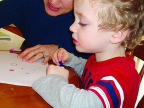 Marianne Hall, occupational therapist, works with junior kindergarten student Felix Wilson during one of her handwriting classes.