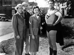 SUBMITTED PHOTO   Superman, played by George Reeves, sweeps in to save the day for Lois Lane (Phyllis Coates) and some good citizens of Metropolis. Reeves wore a grey and white suit when the series was first produced in black-and-white in 1951.
