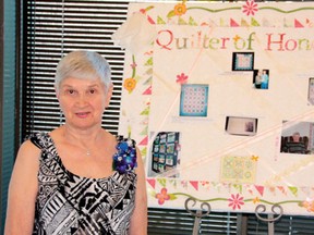2013 Quilter of Honour Adeline Johnson stands by the beginning of her display at the Lake of the Woods Museum. The Lake of the Woods Quilter’s Guild Quilt Show runs from June 18 to July 13.