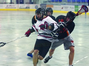 The Fort Saskatchewan Rebels’ captain fights off two Edmonton Wizards in a 11-2 win for the Rebels. The win pushed the Rebels to a 7-3-1 record and was the. Photo by Aaron Taylor.