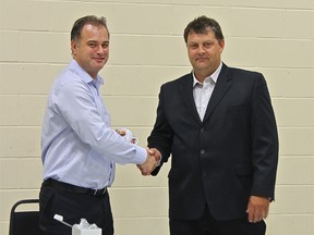 Raymond Poe, True North Chief Operating Officer and Mark Massicotte, Island Falls Forestry General Manager, after they signed the WASA.