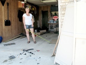 Marg Kloostra of Merritt Avenue in Chatham, On was measuring product in her garage moments before a driver crashed into her parked vehicle pushing it through the garage door on Thursday June 20, 2013. (VICKI GOUGH/ THE CHATHAM DAILY NEWS/ QMI AGENCY)