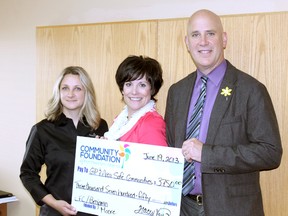 Grande Prairie and Area Safe Communities received a $3,750 cheque on Wednesday to help with location upkeep and improvements on behalf of Benjamin Moore and their partner Community Foundation of Northwestern Alberta. On hand for the cheque presentation were Benjamin Moore’s Grande Prairie location representative Janice Kachnic (left), Executive Director of Grande Prairie and Area Safe Communities Heather Coney, and current chairman of the Community Foundation of Northwestern Alberta Leonard Scharbach. (Jocelyn Turner/Daily Herald-Tribune)