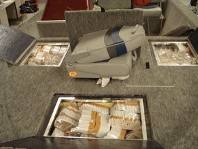Bags of smuggling cigarettes are shown stored in a boat. CRTF photo