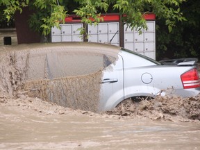 KEVIN RUSHWORTH HIGH RIVER TIMES/QMI AGENCY. High River continues to suffer through its worst flooding in decades. Pictured above, a car is mere moments away from being sucked away by the force of the Highwood River.