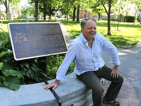 Jamie Swift, sitting in the middle of Skeleton Park, will join Queen's University professor Laura Murray in holding a walking tour around the old Swamp Ward on Saturday.
Michael Lea The Whig-Standard
