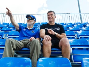 FC Edmonton owner Tom Fath, left, and head coach Colin Miller sit in the stands as players hold a scrimmage at Clarke Stadium  on Saturday, May 18, 2013. Codie McLachlan/Edmonton Sun/QMI Agency