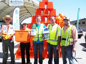 Along with the orange boxes, residents dropping off waste at the Household Hazardous Waste Depot Thursday received a schedule for drop off days, a can of LOOP recycled paint and even an orange for recycling their hazardous waste properly. From left to right: QWS General Manager Rick Clow, Hazardous Waste Co-ordinator Jeanne Vilneff, Neil Patterson from LOOP Recycled Paint, and Corey Graper from Raw Material Company.