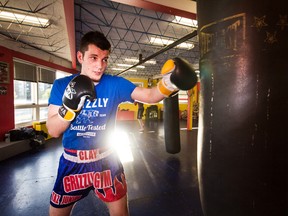 Cody Clay hits the heavy bag at Grizzly Gym, where he trains. Clay won his inaugural Muay Thai fight last weekend in Quebec. (Sam Koebrich/For The Whig-Standard)