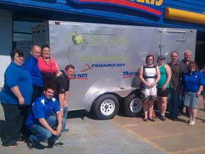 Staff from the Wood Buffalo Food Bank and NAPA Auto Parts pose by a new trailer the local company helped the food bank buy. ANDREW BATES/TODAY STAFF