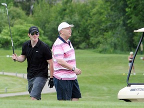 Former North Bay/Brampton Battalion player Matt Duchene, left, shares a laugh with Battalion head coach and GM Stan Butler Thursday at Osprey Links Golf Club in Callander. Duchene was in town for the One Kids Place Charity Golf Tournament.