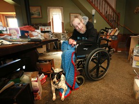 Paul Ambrose and his dog Sasha in his home in Rocklyn. Ambrose says he is now sleeping in his wheelchair because PSWs have stopped their visits.