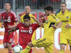 TFC midfielder Matias Laba (left) challenges Matias Sanchez of the Columbus Crew for the ball during an MLS game in May. (Jack Bolland/Toronto Sun Files)