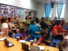 Students, parents and teachers listen to a presentation at the grand opening of the Good Shepherd School out-of-school program Thursday morning. The program offers affordable child care to parents, before and after school hours. Amanda Richardson/TODAY STAFF