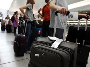 Passengers wait in line to depart before JFK International Airport shuts down at noon in preparation for Hurricane Irene, in New York August 27, 2011. (REUTERS/Jessica Rinaldi)