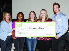 Lucas Ferron (right), representative for the Youth and Philanthropy Initiative, presents a cheque for $5,000 to (from left) Tiffany Hughes, residential supervisor of Columbus House, and presenters Burgundy Morgan, Alexa Meitz and Krista Dunn. Missing is group member Jesse Weddeler.