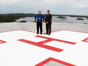 Pat Tessier (left), interim director of facilities management at Health Sciences North, and senior vice-president Joe Pilon stand on the newly repaired rooftop helipad at Ramsey Lake Health Centre.