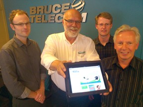 Bruce Telecom launched a free wireless internet service in Lakeside Downtown Kincardine as a partnership with the Kincardine BIA and Municipality of Kincardine from the company's 735 Queen Street store on June 20, 2013. Team Kincardine hopes to partner with Bruce Telecom and the municipality to offer free internet throughout the district in the coming months. L-R: Bruce Telecom CEO Bart Cameron, Kincardine BIA's Ricke Clarke, Bruce Telecom vice president of operations Wayne Eichenberger and Municipality of Kincardine chief administrative officer Murray Clarke. (TROY PATTERSON/KINCARDINE NEWS)